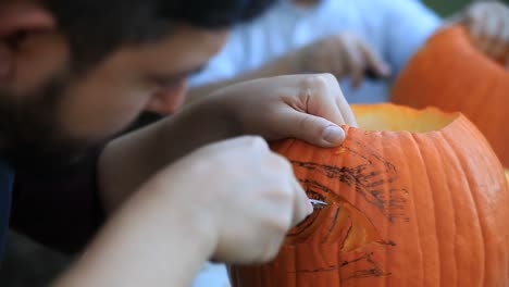 Carving-Halloween-pumpkins-outside