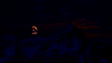 Full-moon-rising-at-night-behind-the-mountains