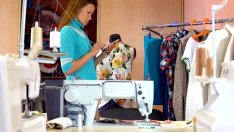 Woman-tailor-working-in-dressmaking-studio.