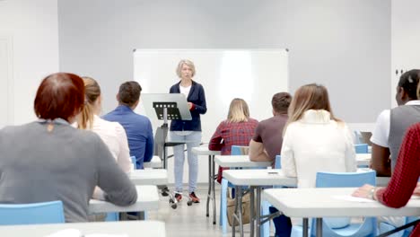 Female-speaker-giving-presentation-for-adult-students