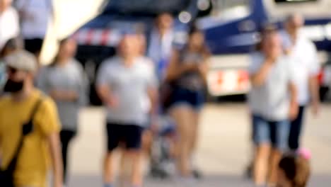 Big-Crowd-Of-People-Walking-Down-A-Street-With-a-Police-Van