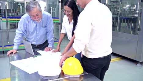 Factory-owner-inspecting-his-production-line.-Asian-senior-man-with-beautiful-asian-female-personal-assistants-and-engineer-talking-inside-factory.