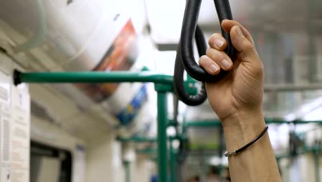 Passenger's-Hand--in-subway-waiting-for-the-stop.Modernity,-speed,-transport