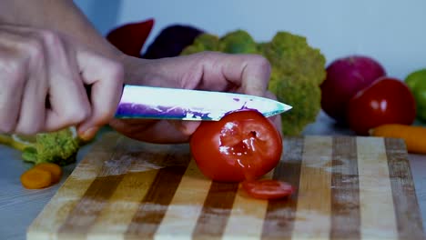 El-hombre-es-vegetales-de-corte-en-la-cocina,-cortar-tomate