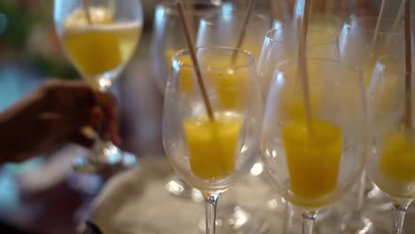 several-glasses-of-champagne-with-yellow-popsicle-ice-cream