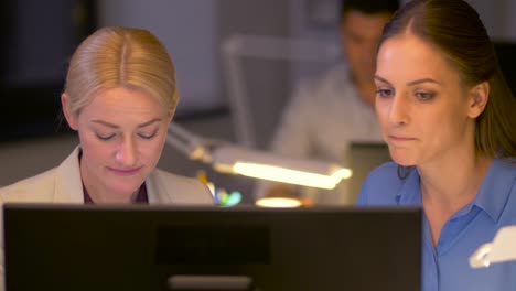 businesswomen-discussing-problem-at-night-office