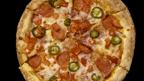 rotation-of-delicious-appetizing-pizza-on-a-black-background