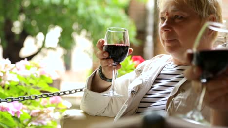 Woman-drinking-wine-in-street-cafe