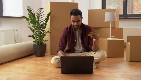 man-with-laptop-shopping-online-at-new-home