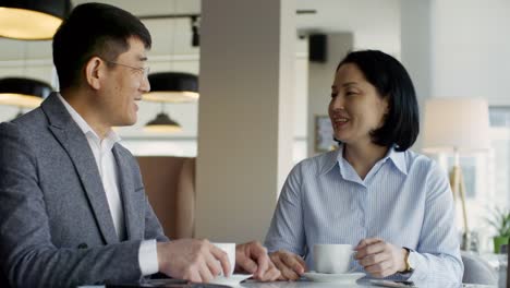 Man-and-Woman-Talking-over-Cup-of-Coffee