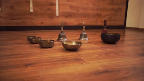 Tibetan-singing-bowls-and-bells-are-on-the-wooden-floor