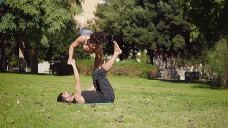 Beautiful-couple-practicing-acro-yoga-in-the-morning