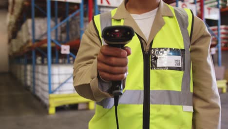 Male-warehouse-worker-wearing-VR-headset-in-loading-bay-4k