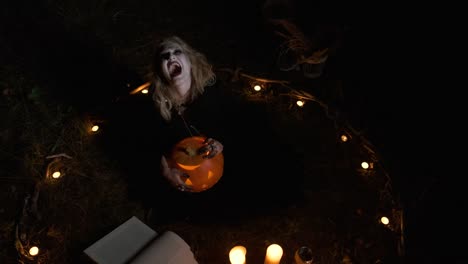 Halloween-Image-.Young-Witch-In-Black-Clothes-Holds-Pumpkin-In-Her-Hands.