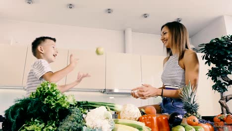 Kitchen-and-food.-Mom-and-son-are-playing-in-the-kitchen.