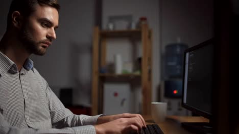 Dolly-shot-of-serious-computer-programmer-working-in-the-office