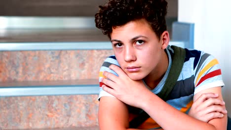 Sad-schoolboy-sitting-alone-on-staircase