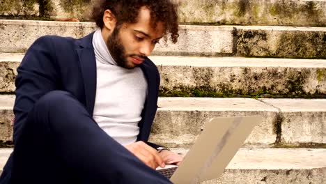 Personnel-consultant-chatting-with-client-by-laptop-on-steps