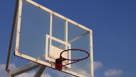 Basketball-cage-against-blue-sky-on-sunny-summer-day