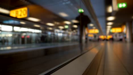 Bottom-view-of-airport-escalator,-people-moving-to-gate-at-passenger-terminal