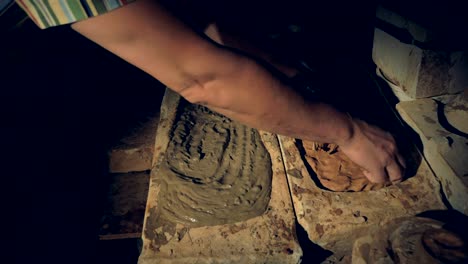 Potters-hands-remove-a-half-dry-slab-of-clay-from-the-mold.