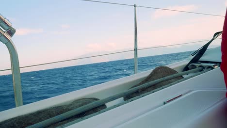 View-of-cliffy-shore-of-Gran-Canaria-in-smoke.-View-from-board-of-yacht-saling-in-ocean