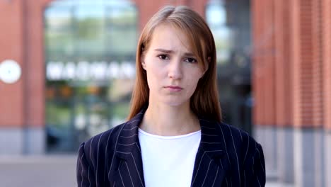 Portrait-of-Sad-Business-Woman-Looking-at-Camera