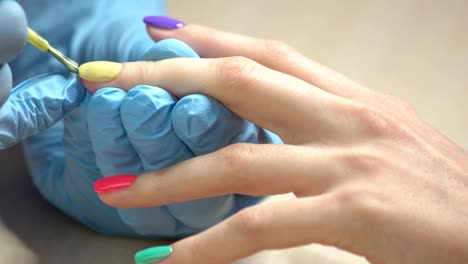 Close-up-manicurist-applying-nail-varnish.