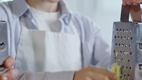 Diligent-Boy-Trying-to-Grate-Cheese