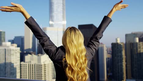 Caucasian-American-female-celebrating-business-success-on-rooftop