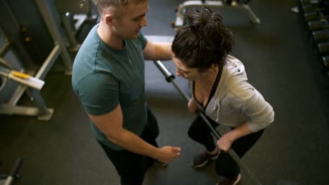 Woman-Training-in-Gym-with-Male-Instructor