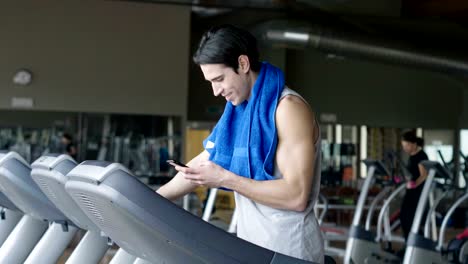 A-shirtless-guy-at-the-gym,-trains-his-body-to-stay-fit-and-have-defined-muscles.-The-athlete-raises-heavy-weights-and-fatigue.