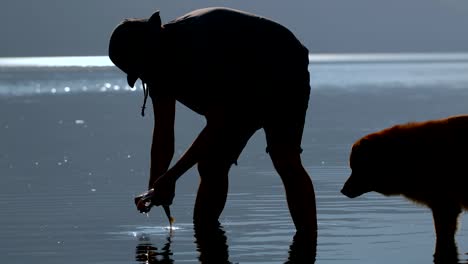 Fisherman-cleaning-a-dead-fish-in-the-river-4k