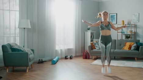 Strong-and-Fit-Beautiful-Girl-in-an-Athletic-Top-Energetically-Exercises-With-Jump/Skipping-Rope-in-Her-Bright-and-Spacious-Living-Room-with-Minimalistic-Interior.