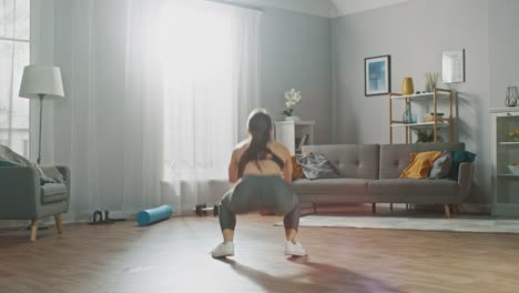 Time-Lapse-Footage-of-a-Strong-and-Fit-Beautiful-Girl-in-a-Grey-Athletic-Outfit-Energetically-Exercising-in-Her-Bright-and-Spacious-Living-Room-with-Minimalistic-Interior.
