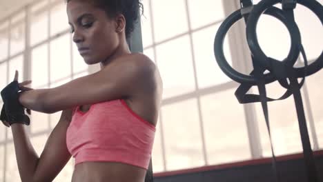 Strong-woman-stretching-her-arms-at-gym