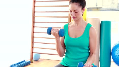 Young-woman-exercising-with-dumbbells