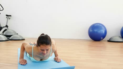 Fit-brunette-doing-yoga-on-exercise-mat