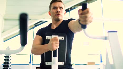 Handsome-sporty-man-is-exercising-in-fitness-club-and-gym-center