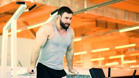 Handsome-sporty-man-is-exercising-in-fitness-club-and-gym-center