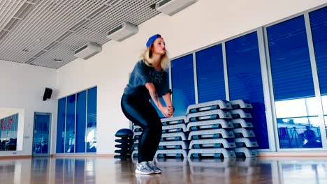 Pretty-girl-in-cap-dancing-the-modern-dance-in-gym