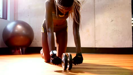 Fit-woman-exercising-with-dumbbell