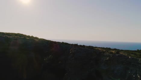 Runner-arrives-on-top-of-a-cliff-on-an-island-and-admires-the-ocean