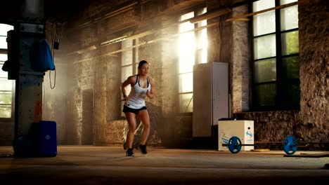 Fit-Athletic-Woman-Does-Footwork-Running-Drill-in-a-Deserted-Factory-Remodeled-into-Gym.-Fitness-Exercise/-Workout-Aimed-at-Strengthening-Legs,-Enhancing-Her-Agility-and-Speed.