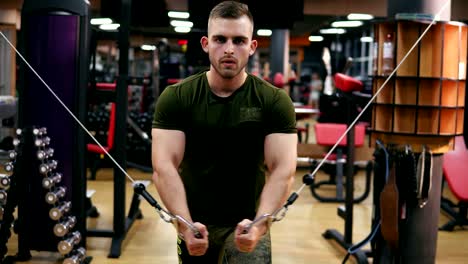 Handsome-athletic-man-doing-pectorals-on-the-crossover-trainer-in-the-gym.-Shot-in-4k