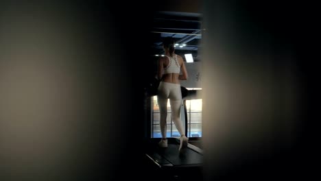 Fitness-woman-training-cardio-exercise-on-treadmill-in-healthy-club-back-view