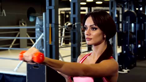 The-beautiful-girl-is-diligently-doing-exercises-for-hands