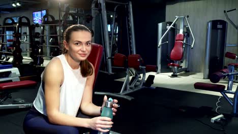 The-cute-girl-drinks-water-in-a-break-between-training-sessions