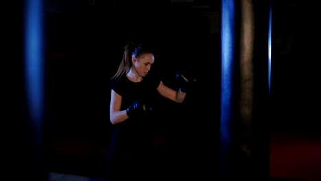 Girl-is-boxing.-Beautiful-kickboxing-woman-training-punching-bag