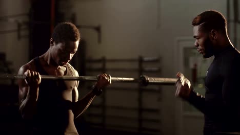 Athletic-black-men-working-out-in-gym-together